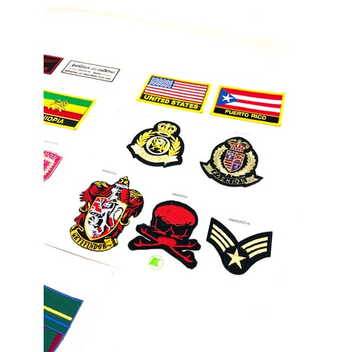 27 - Selection of assorted fabric cap badges