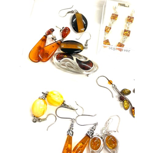 565 - Selection of mainly silver and amber style ladies costume jewellery