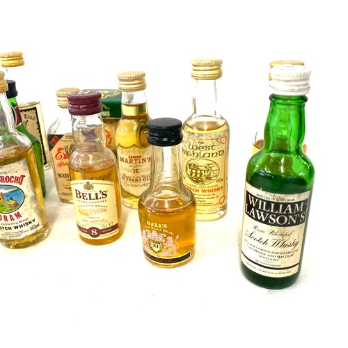 167 - Large selection of whiskey alcohol miniatures includes bells whiskey etc