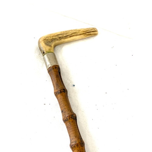 147 - 2 Vintage and later walking sticks, to include a bone handle, metal fish handle