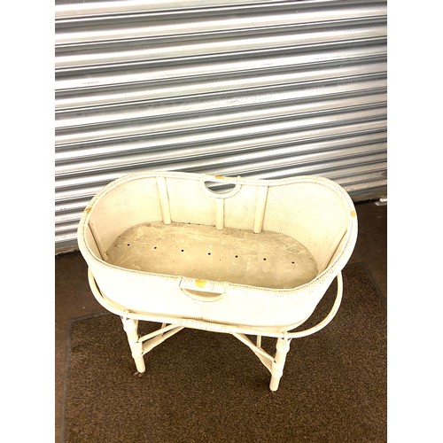 412 - Vintage child wicker crib on wheels, measures 32.5