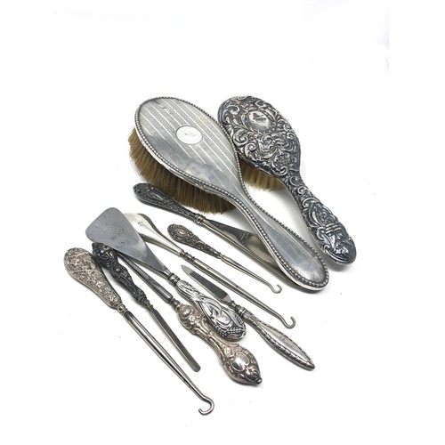 20 - selection of silver items includes brushes shoe horn button hooks etc