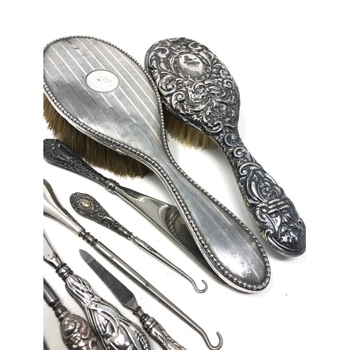 20 - selection of silver items includes brushes shoe horn button hooks etc