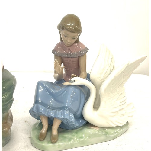 62 - Nao large girl figure, sitting on rocks, girl figure with swan, both in good overall condition