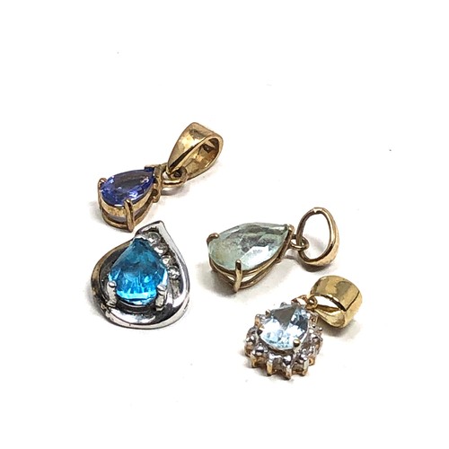 505 - 4 x 9ct gold and silver pendants includes topaz, diamond, tanzanite & clear stone pendants