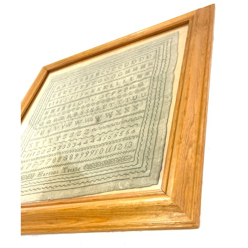 76 - Framed antique sampler in later frame by Harriot Tuttle, overall frame measurements 18 inches square