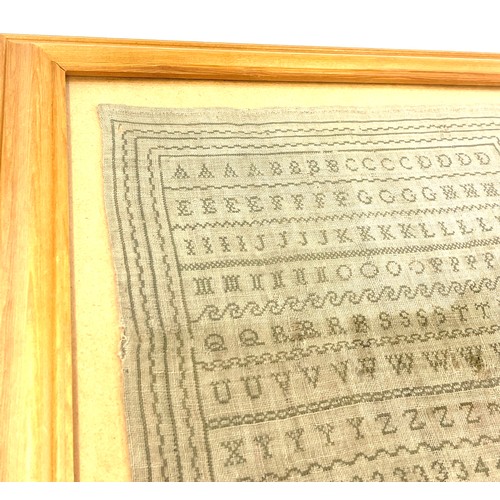 76 - Framed antique sampler in later frame by Harriot Tuttle, overall frame measurements 18 inches square