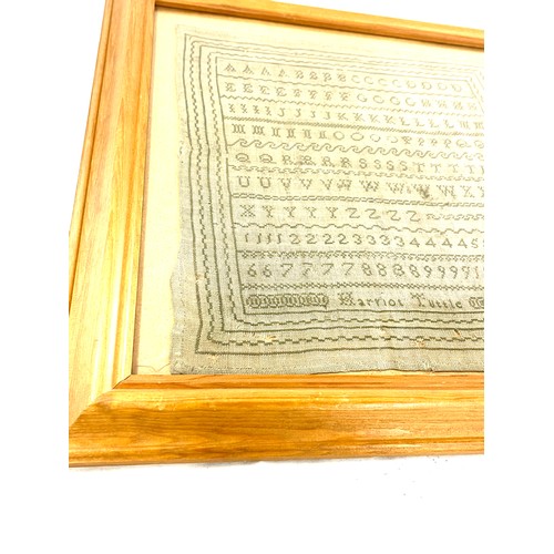 76 - Framed antique sampler in later frame by Harriot Tuttle, overall frame measurements 18 inches square