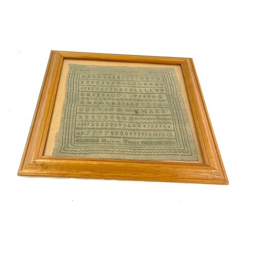 76 - Framed antique sampler in later frame by Harriot Tuttle, overall frame measurements 18 inches square