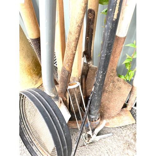 100E - Selection of garden tools to include pick axes, post hole diggers, spades etc.