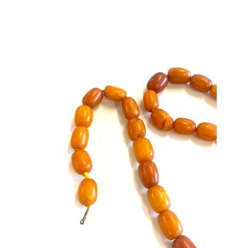 503 - Antique egg yolk amber bead necklace for re stringing total weight approx 42 grams, length 53cm