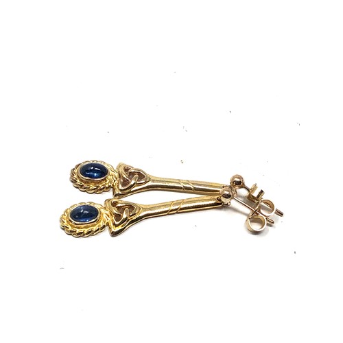124 - 9ct gold sapphire celtic knot long drop earrings (3.9g)