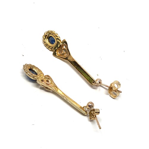 124 - 9ct gold sapphire celtic knot long drop earrings (3.9g)