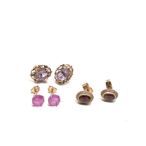 167 - 3 x 9ct gold gemstone stud earrings inc. amethyst, garnet & pink sapphire (3.8g)