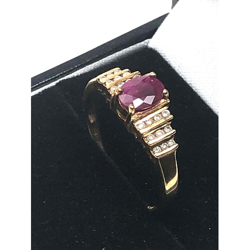 90 - 9ct gold ruby & diamond ring central ruby measures approx 7mm by 5.5 with diamonds either side weigh... 