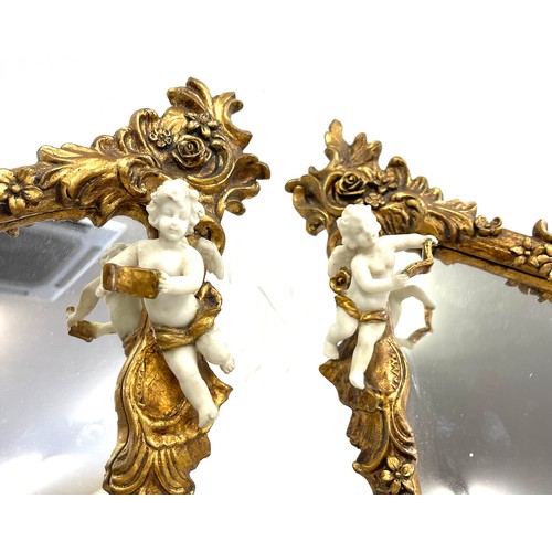 125 - Pair of gilt framed cherub ornamental free standing mirrors measures approx 16 inches tall 11 inches... 