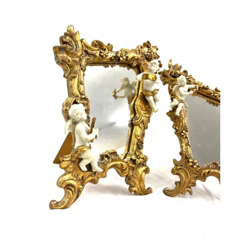 125 - Pair of gilt framed cherub ornamental free standing mirrors measures approx 16 inches tall 11 inches... 