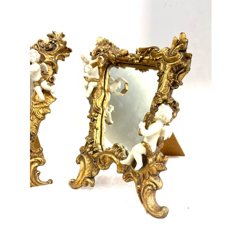 125 - Pair of gilt framed cherub ornamental free standing mirrors measures approx 16 inches tall 11 inches... 