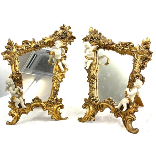 125 - Pair of gilt framed cherub ornamental free standing mirrors measures approx 16 inches tall 11 inches... 