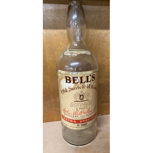 132 - Vintage tall Bells Whiskey glass bottle with screw lid, approximate height: 19.5 inches