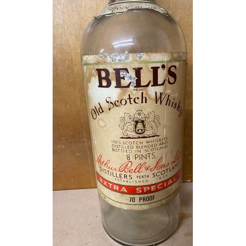 132 - Vintage tall Bells Whiskey glass bottle with screw lid, approximate height: 19.5 inches