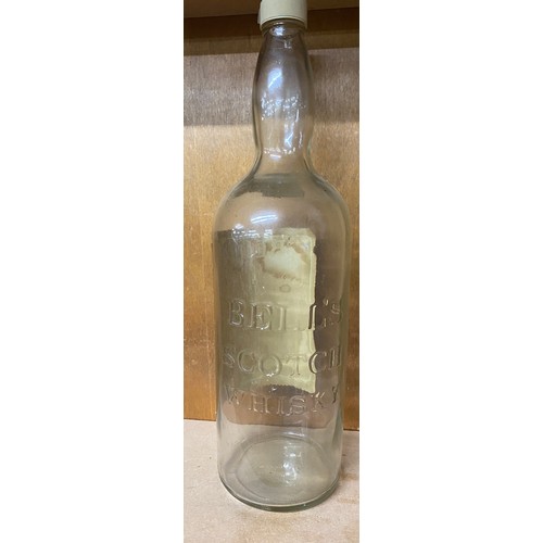 132 - Vintage tall Bells Whiskey glass bottle with screw lid, approximate height: 19.5 inches