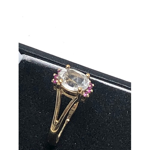 295 - 9ct gold topaz & ruby ring (2.6g)