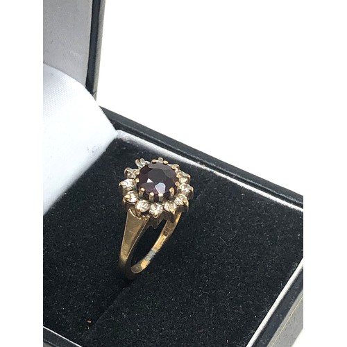 315 - 9ct gold garnet & clear stone halo ring (2.7g)