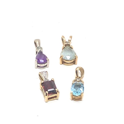 216 - 4 x 9ct gold gemstone pendants inc. topaz, garnet, amethyst & diamond (3.6g)