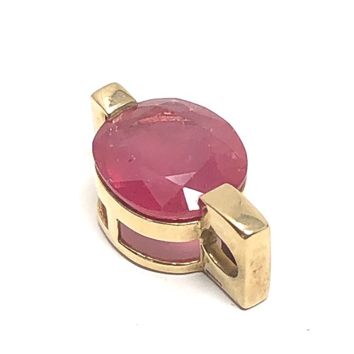 154 - 9ct gold framed ruby pendant (4.4g)