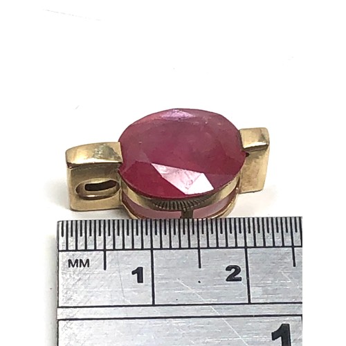 154 - 9ct gold framed ruby pendant (4.4g)