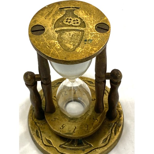 596 - Vintage brass egg timer measures approx 4 inches tall