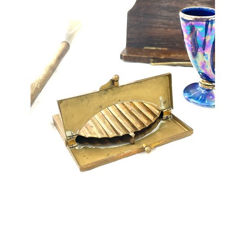 71 - Assortment of items to include a novelty cigarette holder, pencil sharper, wooden music table top st... 