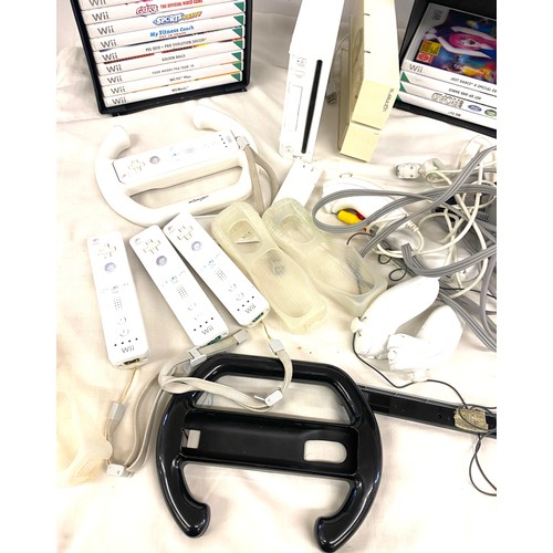 268 - Nintendo Wii console and accessories to include remotes, remote covers, steering equipment and games... 