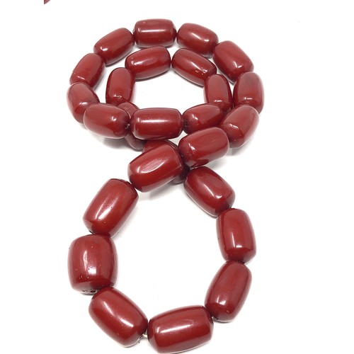 63 - 2 Fine heavy barrel shaped cherry amber / bakelite necklaces both have internal streaking total weig... 