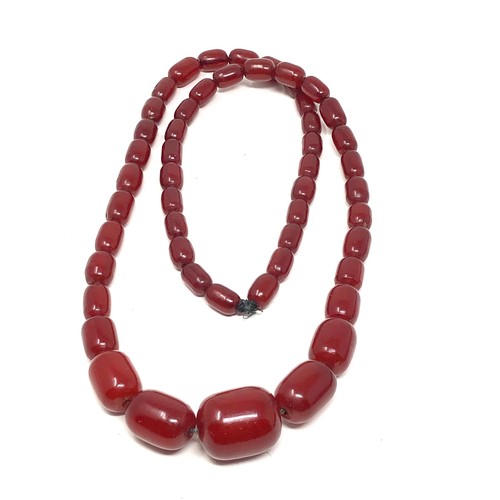 63 - 2 Fine heavy barrel shaped cherry amber / bakelite necklaces both have internal streaking total weig... 