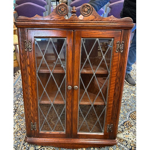 551 - Oak leaded front corner cabinet, approximate measurements: Height 40.5 inches, Width 27 inches, Dept... 