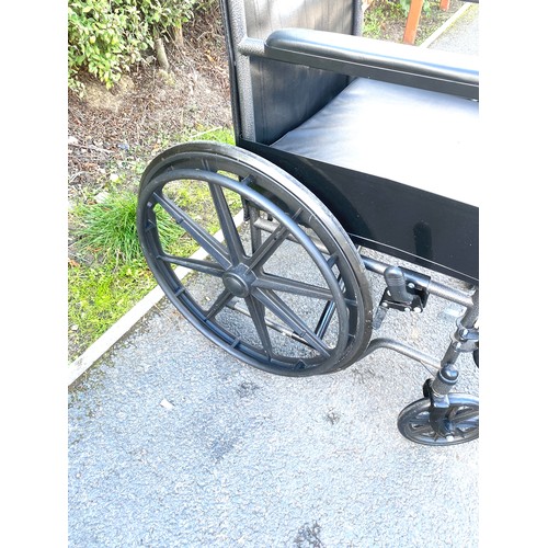 554 - Adult wheelchair with cushion and foot plates