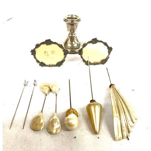 443 - Selection of vintage ladies hat pins, a silver candle stick and 2 miniature photo frames