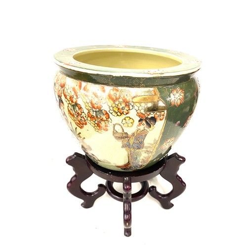 157 - Oriental Decorative green planter on a wooden stand, total height 14 inches, diameter 10 inches