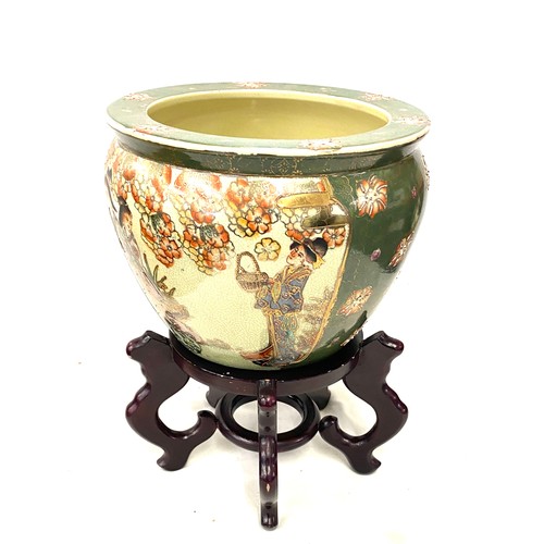 157 - Oriental Decorative green planter on a wooden stand, total height 14 inches, diameter 10 inches