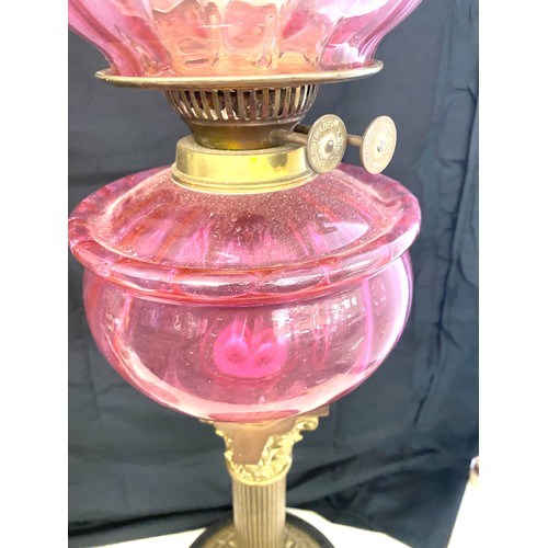 423 - Victorian Nelsons column brass oil lamp with funnel, pink shade and font, approximate overall height... 