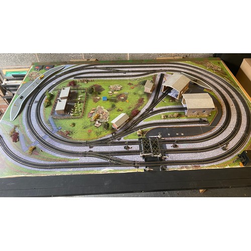 577 - Table top model train layout with buildings and accessories, this measures approximately Length 72 i... 