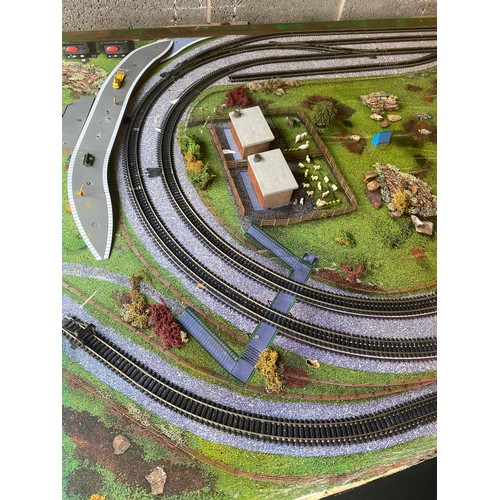 577 - Table top model train layout with buildings and accessories, this measures approximately Length 72 i... 