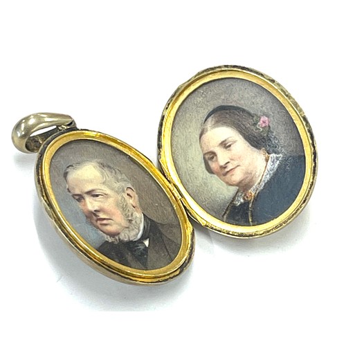 457 - Unmarked victorian silver locket containing two hand painted portrait miniatures, size not including... 