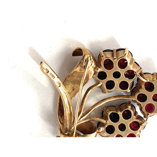 521 - 9ct gold and garnet flower brooch total weight 12 grams