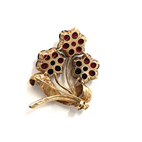 521 - 9ct gold and garnet flower brooch total weight 12 grams