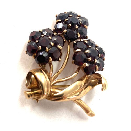 521 - 9ct gold and garnet flower brooch total weight 12 grams