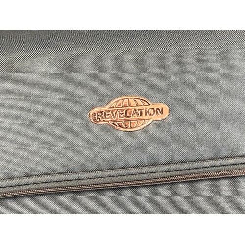 251 - 2 Large Revelation suitcases