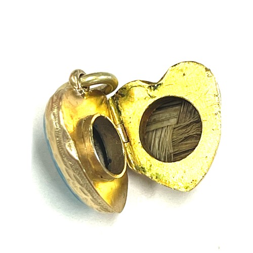 564 - Unmarked yellow metal, enamel and seed pearl locket, tests as 15ct gold, approximate weight 5.5g